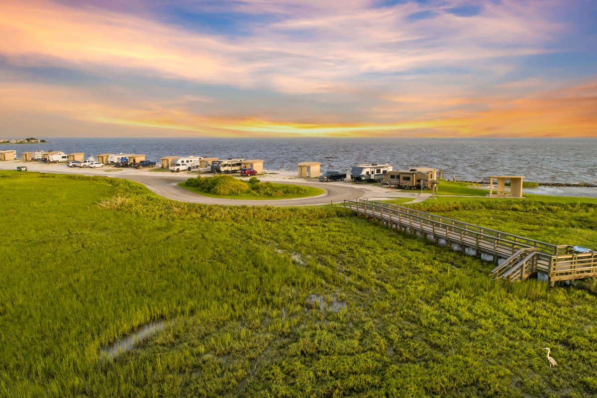 A view of RVs at a camp site by the bay.