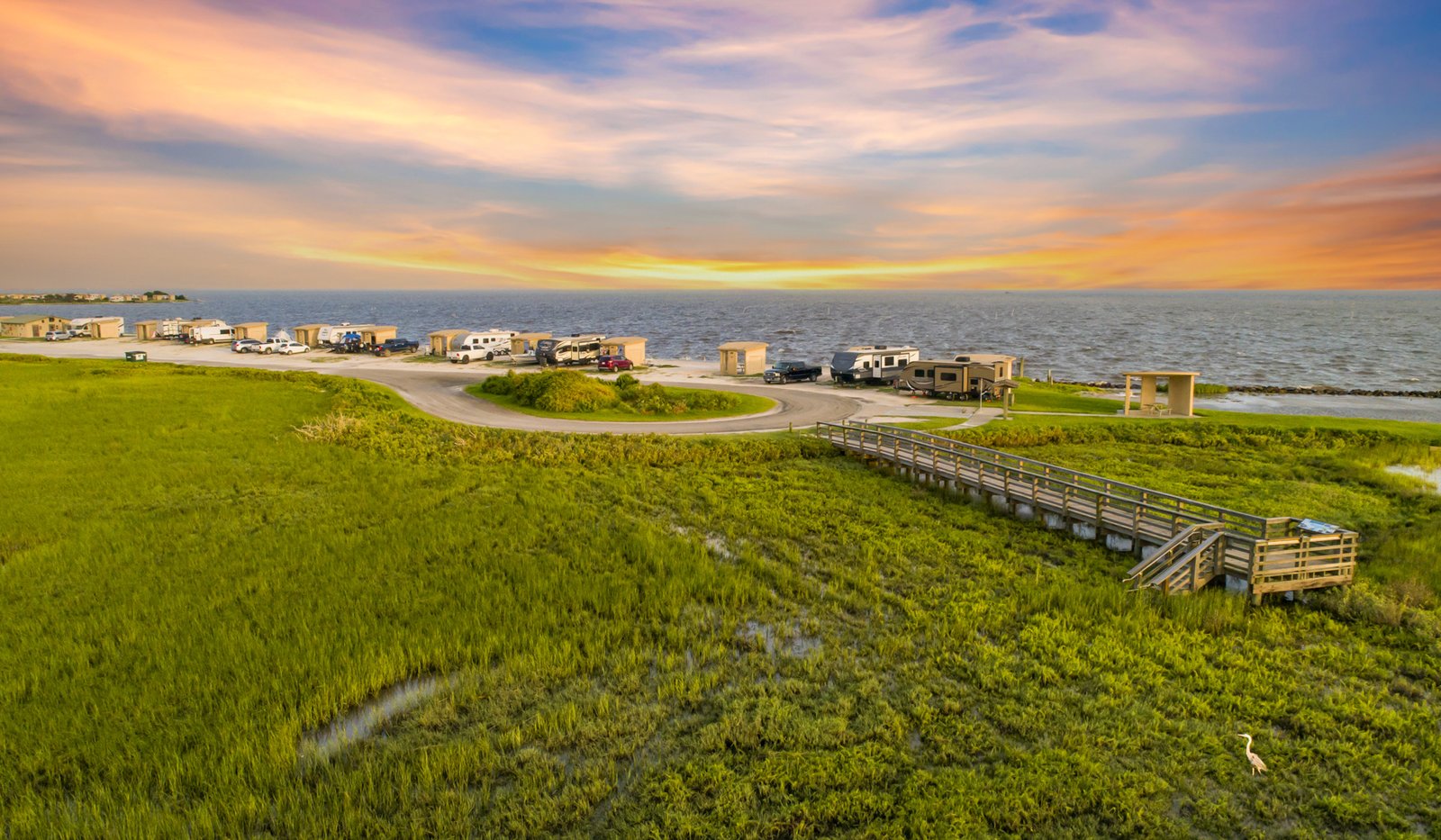 A view of RVs at a camp site by the bay.