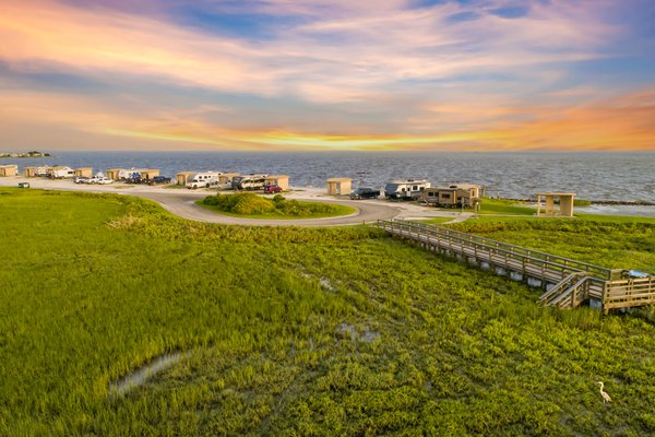 A view of RVs at a camp site by the bay.