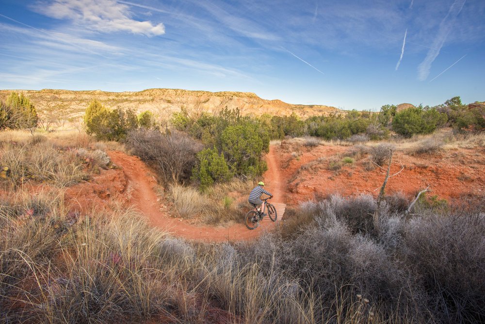 A dirt bike trail winding through hills.