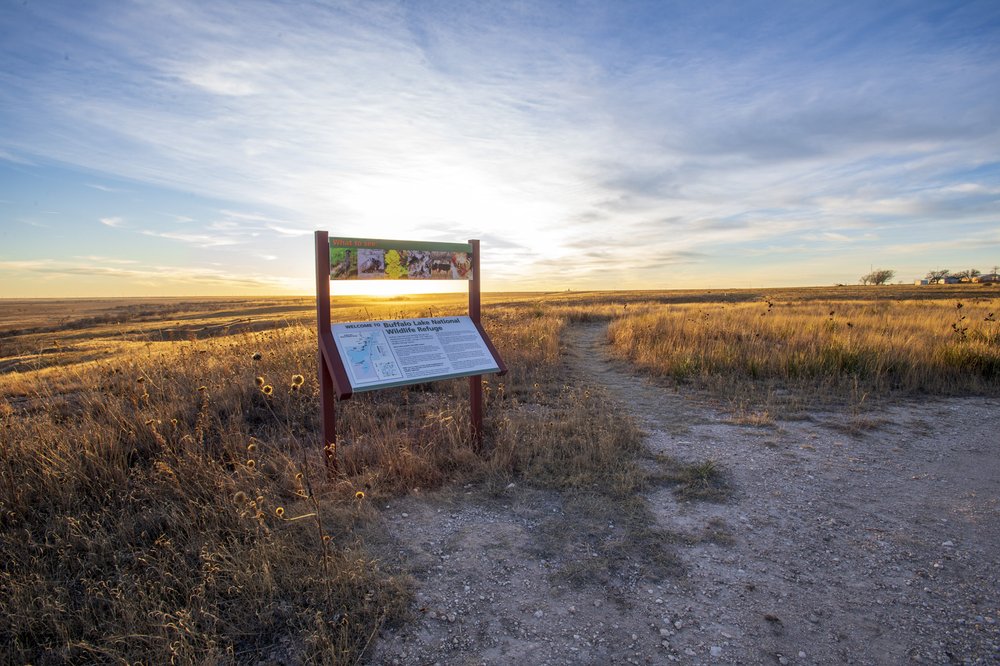 Welcome sign for Buffalo Lake National Wildlife Refuge in a grassy field.