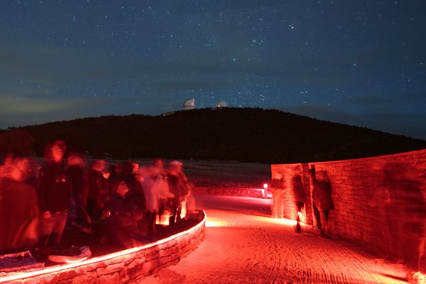 Davis Mountains State Park at night. The Observatory is illuminated in the background.
