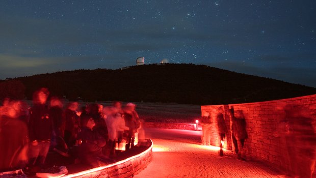 Davis Mountains State Park at night. The Observatory is illuminated in the background.