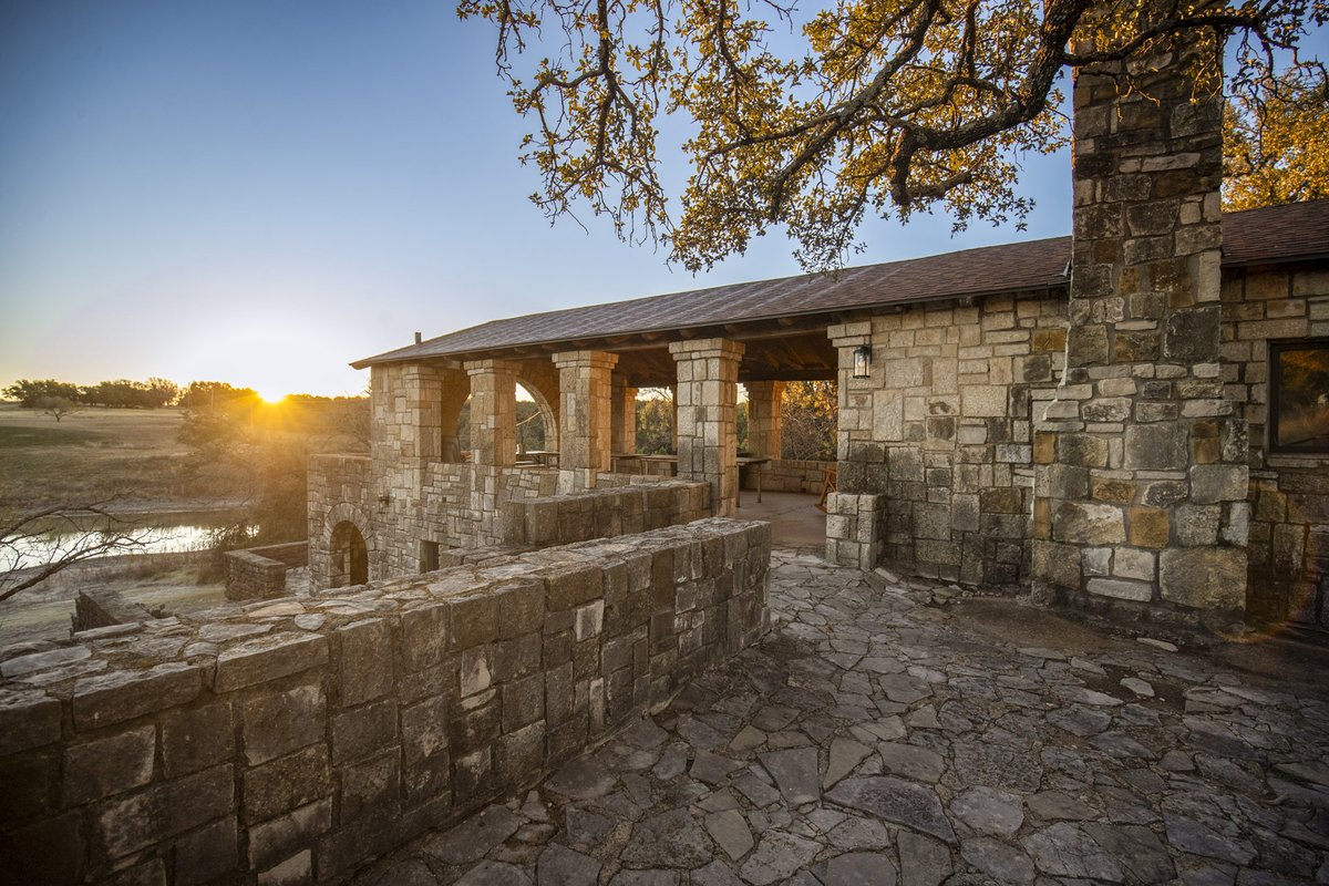 CCC Pavillion next to lake with sun setting behind it