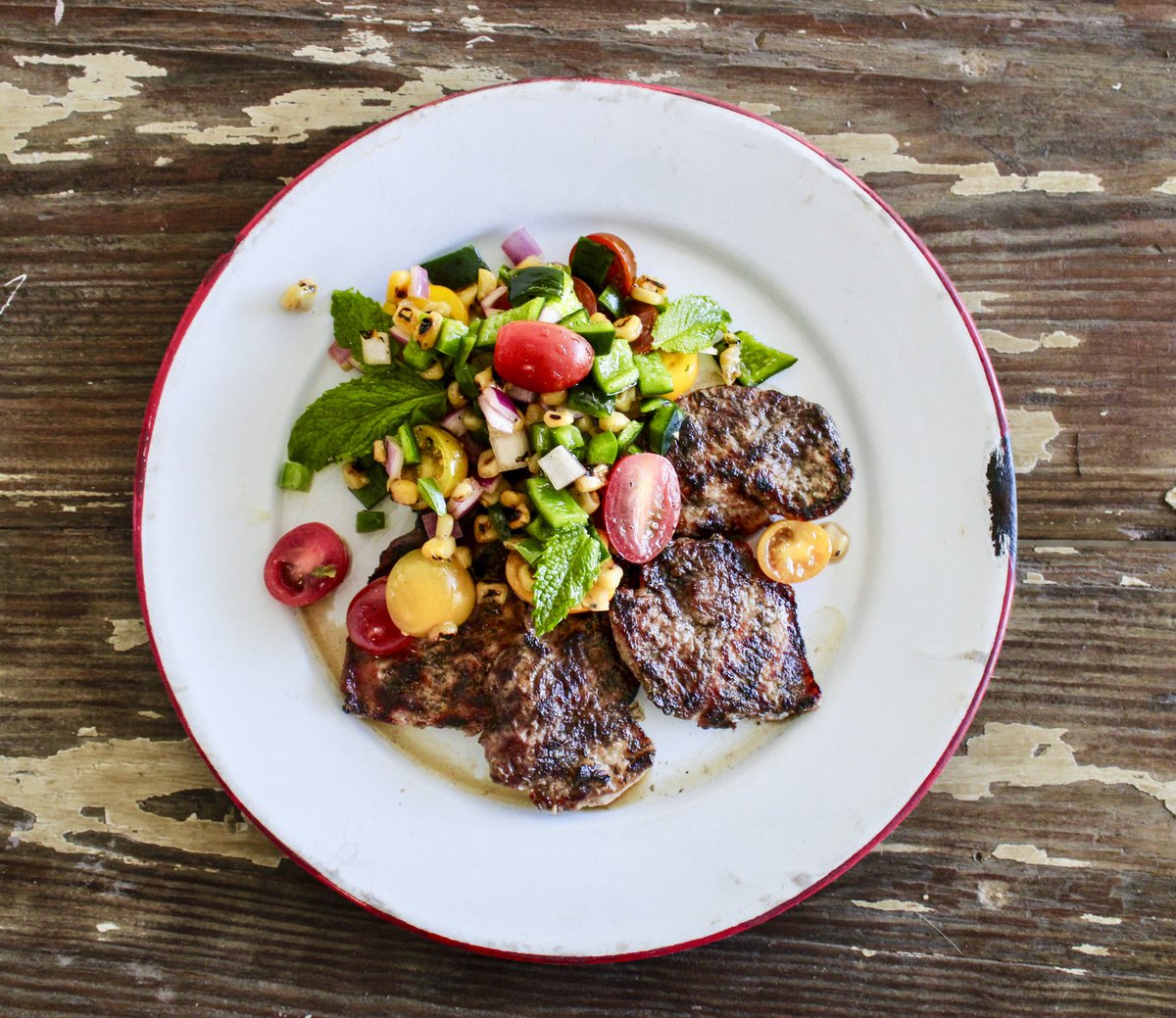 Grilled hog backstrap on a white plate.