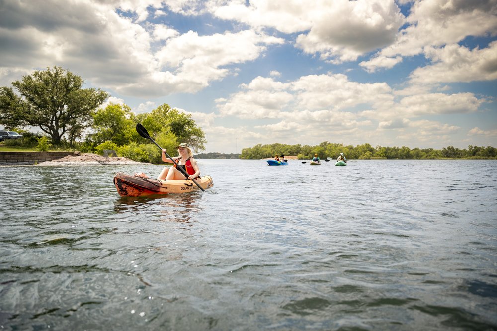 People paddling in boats on a lake.