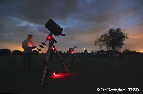 Telescopes set up in a field for stargazing