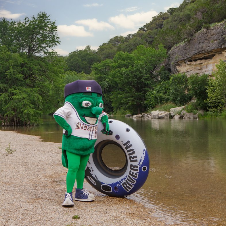 The San Antonio Missions mascot Ballapeno with a tube at Guadalupe River.