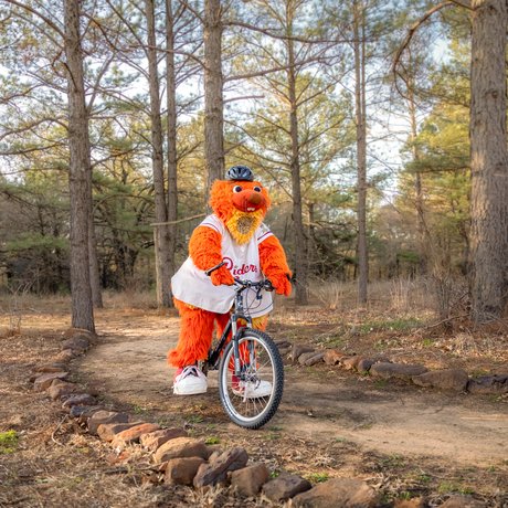 Frisco RoughRiders mascot Deuce biking at Ray Roberts.