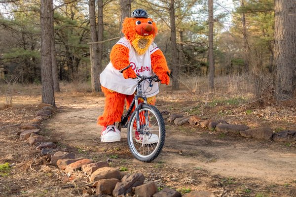Frisco RoughRiders mascot Deuce biking at Ray Roberts.