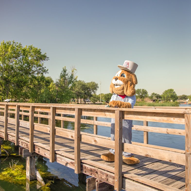 Round Rock Express mascot Spike fishing off the pier at Inks Lake State Park.