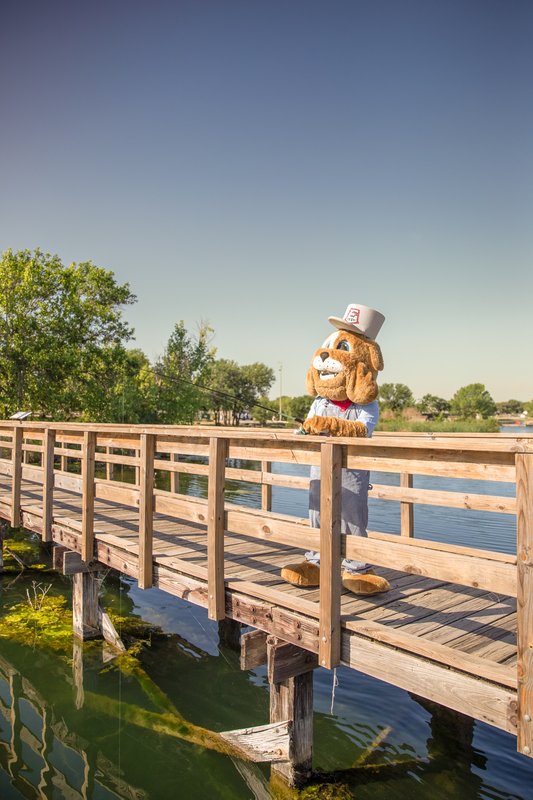 Round Rock Express mascot Spike fishing off the pier at Inks Lake State Park.