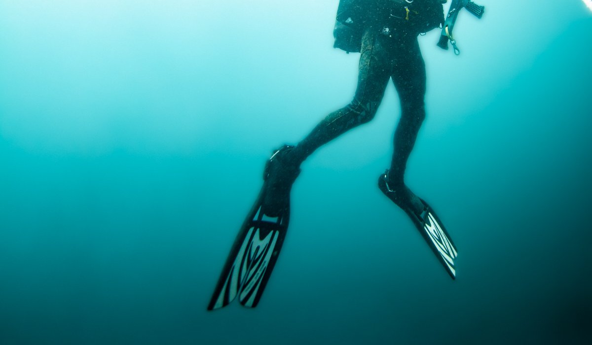 Man rising from deep ocean water.