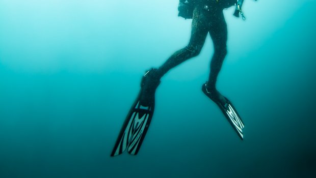Man rising from deep ocean water.
