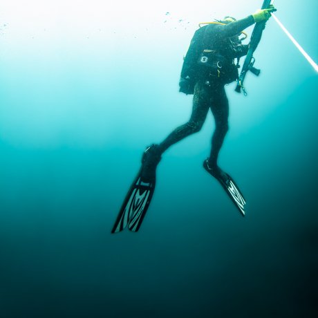 Man rising from deep ocean water.