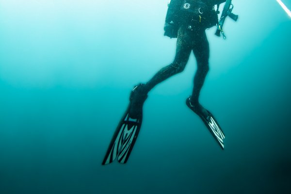 Man rising from deep ocean water.