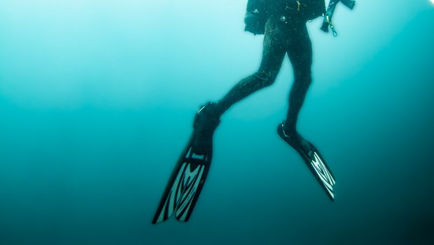 Man rising from deep ocean water.