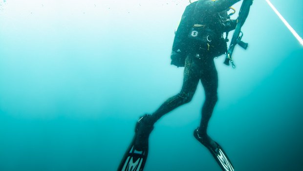 Man rising from deep ocean water.