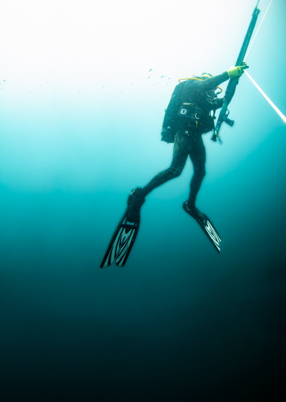 Man rising from deep ocean water.