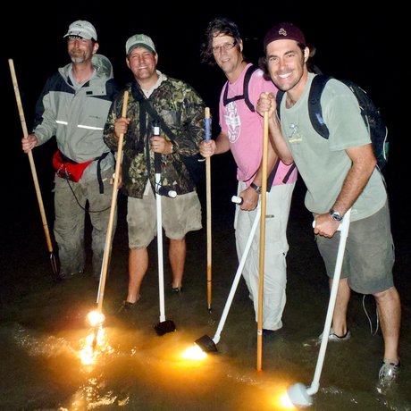 Gigging for flounder at night.
