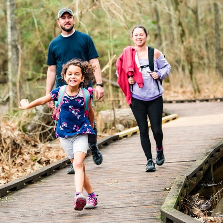 Family walking on boardwalk at Lake Livingston.