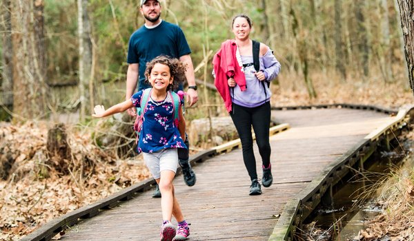 Family walking on boardwalk at Lake Livingston.