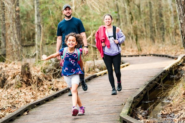 Family walking on boardwalk at Lake Livingston.