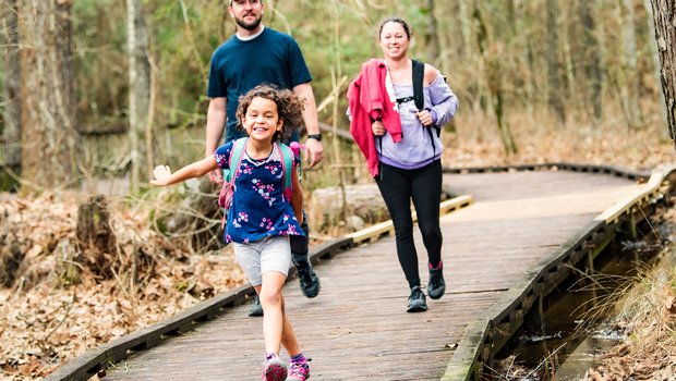 Family walking on boardwalk at Lake Livingston.