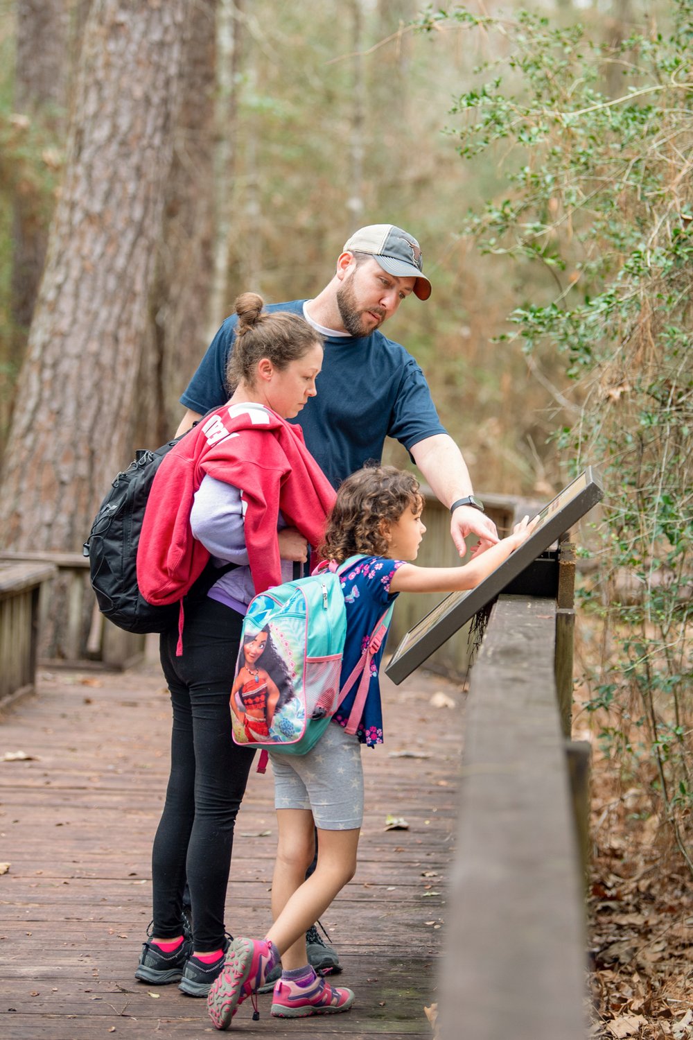 Family looking at a map at Lake Livingston.