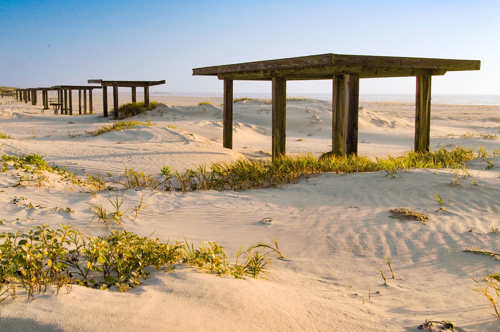 Beach shelter near sand dunes.