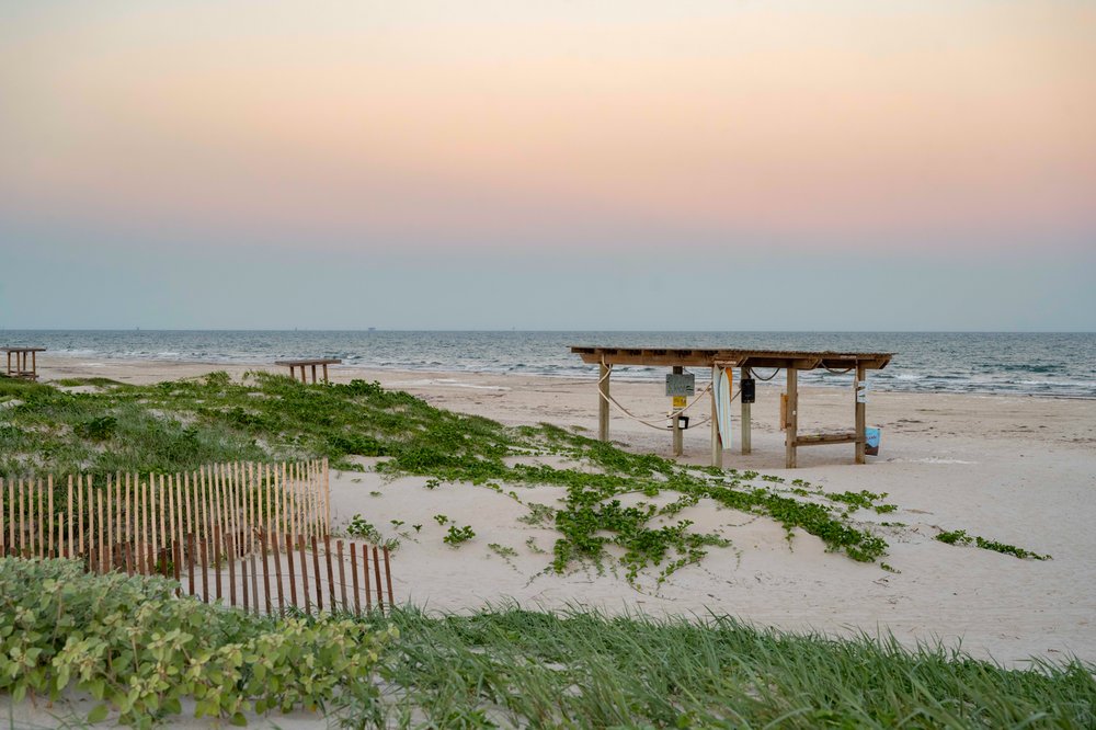 Beach shelter with view of ocean and sunrise.