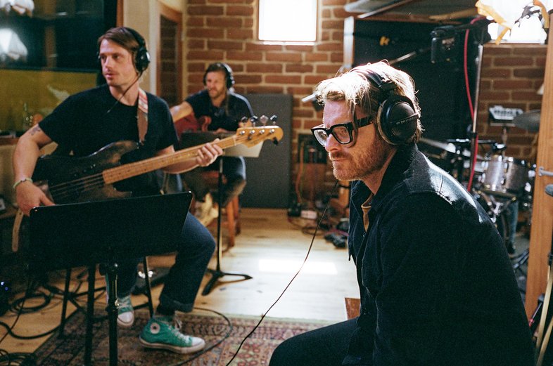 Musicians recording in a studio.