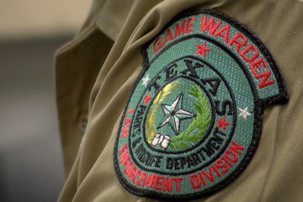 Game warden patch displayed on uniform arm.