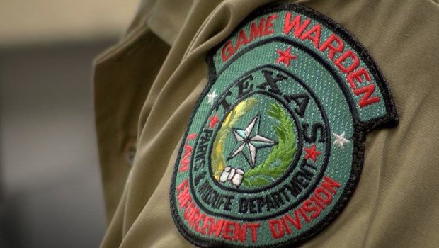 Game warden patch displayed on uniform arm.