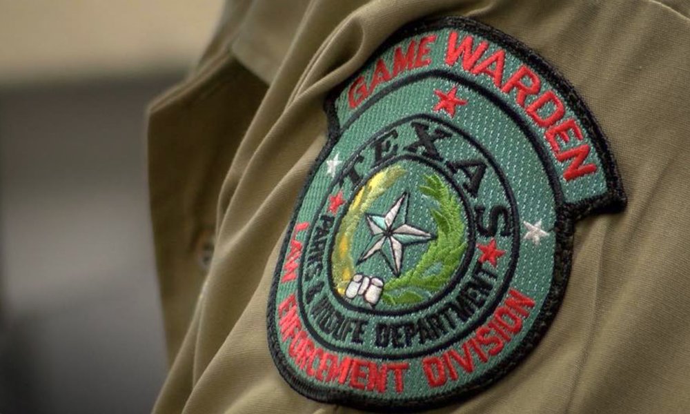 Game warden patch displayed on uniform arm.