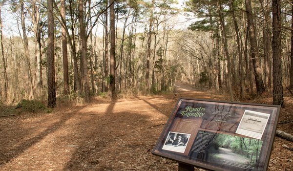 A sign with historic information about park use before desegregation at Tyler State Park.