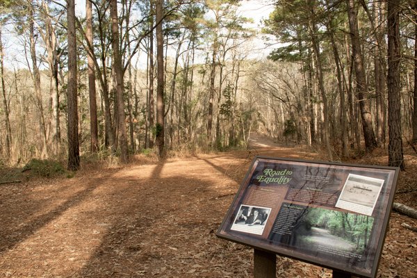 A sign with historic information about park use before desegregation at Tyler State Park.