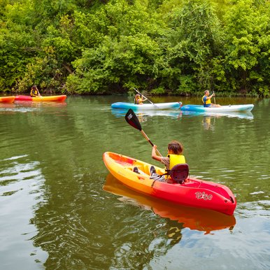 Children kayaking on the Blanco river.