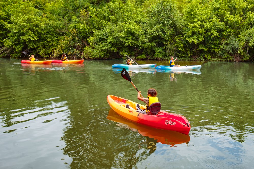 Children kayaking on the Blanco river.