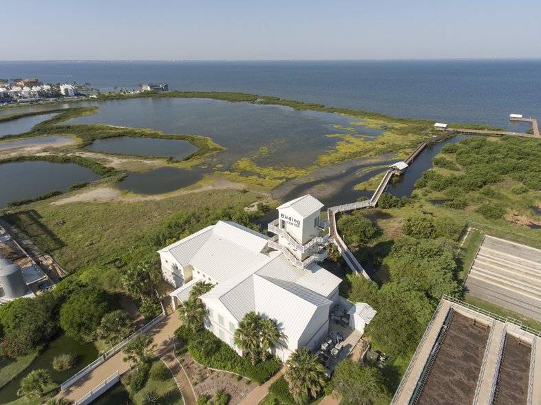Aerial view of the South Padre Birding and Nature Center and its white observation tower