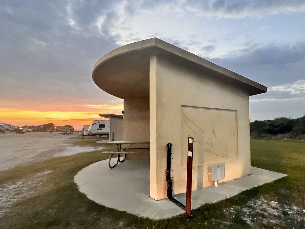 A three-sided covered camping shelter at Goose Island State Park