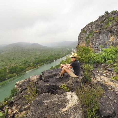 Pam LeBlanc sits on a rock overlooking the Devils River