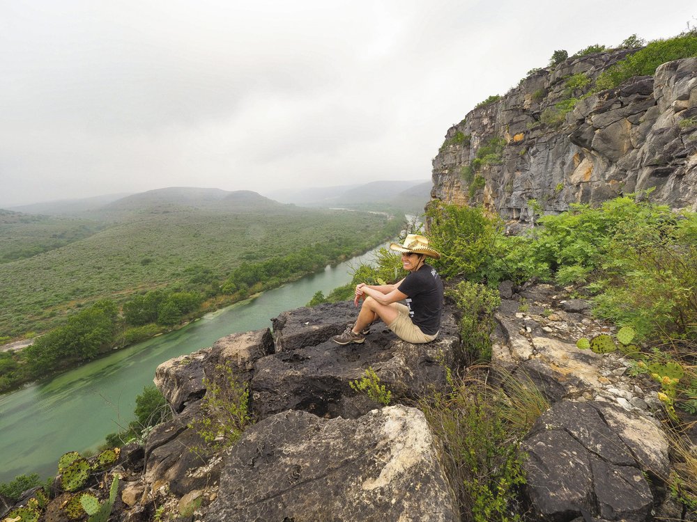 Pam LeBlanc sits on a rock overlooking the Devils River