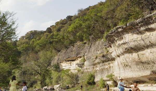 Swimmers, paddlers and anglers enjoy the cliff-lined waters of Guadalupe River State Park