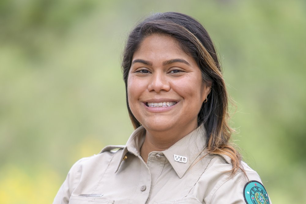 A head and shoulders shot of Ranger Tanguma in her uniform at Guadalupe River State Park