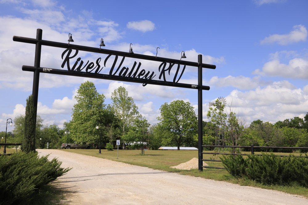 A large archway reads River Valley RV at the entrance to the RV park