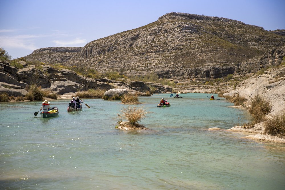 Group of women paddling along the Devils River in pristine aqua waters