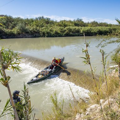 Kayaker paddling over a spillway on the Rio Grande River