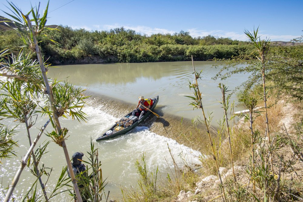 Kayaker paddling over a spillway on the Rio Grande River