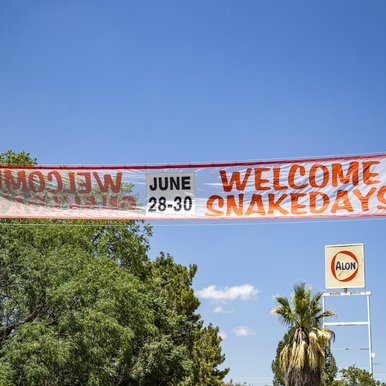 Sign for Snake Days draped over roadway in Alpine Texas